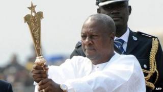 Ghanaian President John Mahama raises the staff of office after swearing to an oath of office at the Independence Square, Accra in January 7. 2013.