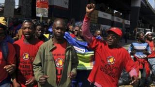Members of the National Union of Mineworkers (NUM) take part in a strike in the central business district area of Johannesburg, August 27, 2013.