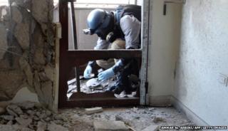 A UN inspector painstakingly gathers samples at the site of an alleged chemical attack. These will be analysed in labs across the world