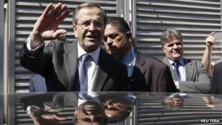 Antonis Samaras (L) waves as he leaves the International Trade Fair of Thessaloniki