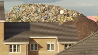 House with rubbish behind it - archive image