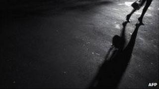 Woman walking on dark street