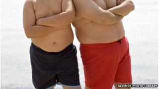 Men on beach in swimming shorts