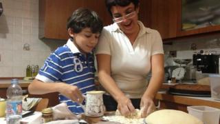 Giovanna Azi cooks with her son