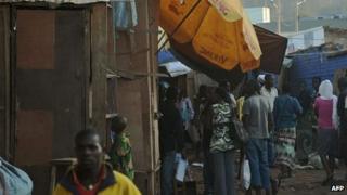 People gather at the scene of a blast at Kigali's main market
