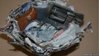 Handgun wrapped in newspaper