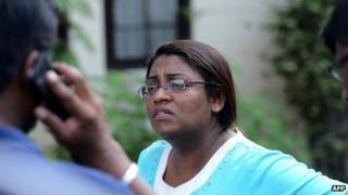 In this photograph taken on August 24, 2013, Associate Editor of Sri Lankan newspaper Sunday Leader , Mandana Ismail Abeywickrema speaks with colleagues hours after police opened fire and killed an intruder at her home in Colombo.