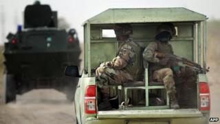Nigerian soldiers patrol in the north of Borno state close to a Islamist extremist group Boko Haram former camp (June 2013)