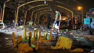 People inspect the site of a double suicide bomb attack, in the Shiite neighborhood of Sadr city in Baghdad, Iraq on 21 September 2013