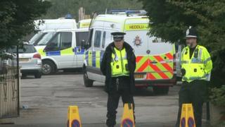 Police at the scene of the raid at Cariad Farm, Peterstone, on Monday