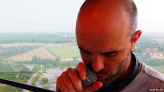 Cian Ciaran holding a microphone