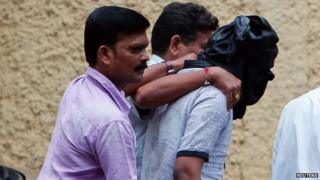 File photo of Indian police escorting a masked rape suspect into Mumbai court on 24 August 2013