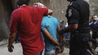 Man is detained by Egyptian security forces during operation against Islamist stronghold in Giza's Kerdasa district, south of Cairo, on 26 September 2013