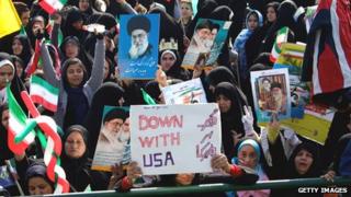 Iranian demonstrators hold anti-US slogans and portraits of supreme leader, Ayatollah Ali Khamenei during a rally in Tehran's Azadi Square in February 2013