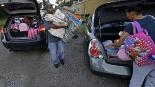 A couple prepare to leave ahead of the storm in Belair, Louisiana, on 4 October.