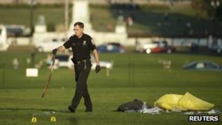 Police officer collects a belt at the scene where a man set himself on fire on the National Mall in Washington DC, 4 October 2013