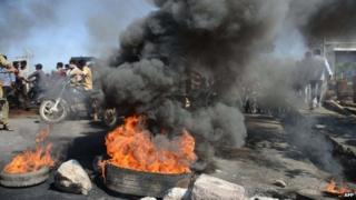 Supporters of united Andhra Pradesh set burning barricades during a protest against the formation of Telangana state, in Kurnool district some 200 kms from Hyderabad on October 5, 2013.