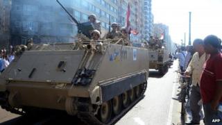 Egyptian troops patrol a street in the northern city of Alexandria (20 September 2013)