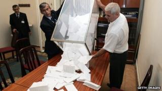 Tajik election officials empty a ballot box after the 2006 presidential election
