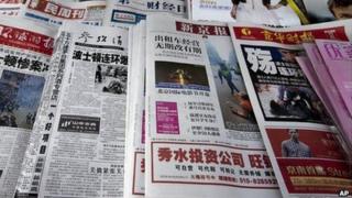 Chinese newspapers with the headlines of Boston Marathon bombings that killed three and wounded more than 170 people, are sold at a newsstand in Beijing, China Wednesday, April 17, 2013.