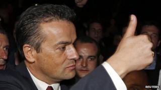 National Front party candidate Laurent Lopez gives a thumbs up after winning the second round of the local by-election in Brignoles on 13 October 2013.