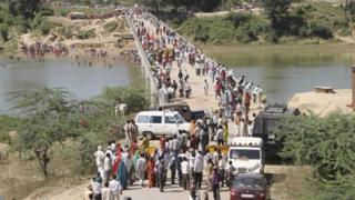 Officials say a rumour that the bridge was about to collapse may have triggered the stampede