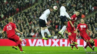Wayne Rooney heading the ball against Poland