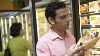 A man looks at a frozen food product