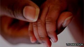 Adult holding child's hand