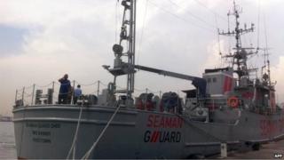 Indian personnel stand on the deck of the Seaman Guard Ohio at a dock in Tuticorin on October 18, 2013