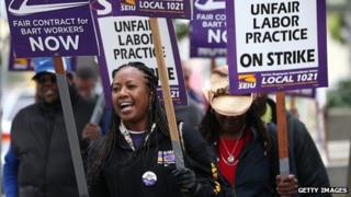 Striking Bart staff members picket in front of Lake Merritt station in Oakland