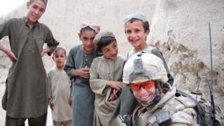 Capt Ashley Collette with local children in Afghanistan