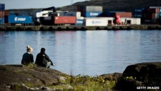 A couple sit overlooking Torshavn harbour in the Faroe Islands