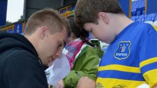 Phil Jagielka signs James Greenop's shirt