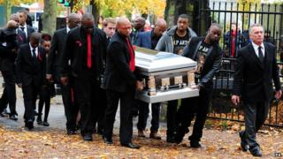 The coffin bearing Antoin Akpom is carried into St Peter's Church