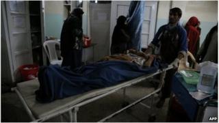 Medics carry a victim of a roadside bomb at a hospital in the Andar district of the Ghazni province on 27 October.