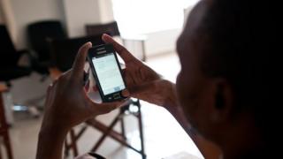Woman in Tanzania using mobile phone