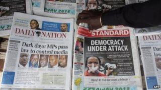 A newspaper vendor sells newspapers carrying headlines commending a new media bill on 1 November 2013 in Nairobi. Kenya