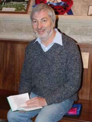 Man with heated cushion in church. Pic: Exeter Diocese