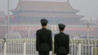 Paramilitary police officers stand guard near Tiananmen Gate in Beijing, 28 October, 2013