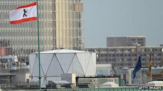 The Berlin flag flies next to a white structure that, according to media reports, contains sophisticated electronic surveillance equipment and stands on top of the British embassy