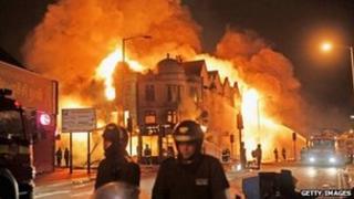 Firefighters battle a large fire that broke out in shops and residential properties in Croydon