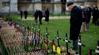 Man looking at crosses