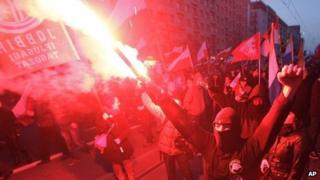 People hold burning flares during a march in Warsaw. Photo: 11 November 2013