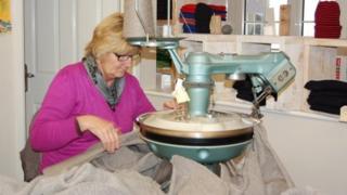 Woman making a Guernsey jumper