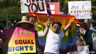 Supporters of same-sex marriage celebrate while the Hawaii State Senate convenes to approve the bill to legalise same-sex marriage in Honolulu, 12 November