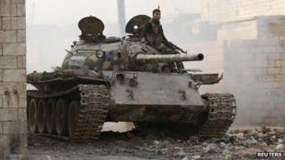 A rebel fighter from Liwa al-Tawhid on board a tank in Aleppo (12 November 2013)
