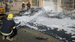 Firefighters put out a car fire after a blast in Kirkuk, Iraq (14 November)