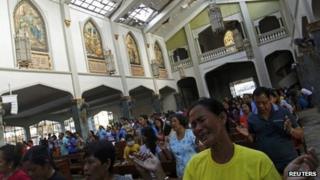 A devotee cries during Sunday Mass at Santo Nino Church in Tacloban. Photo: 17 November 2013