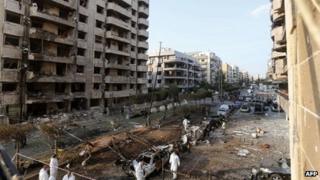 Forensic experts work on the site of a double suicide bombing outside Iran's embassy